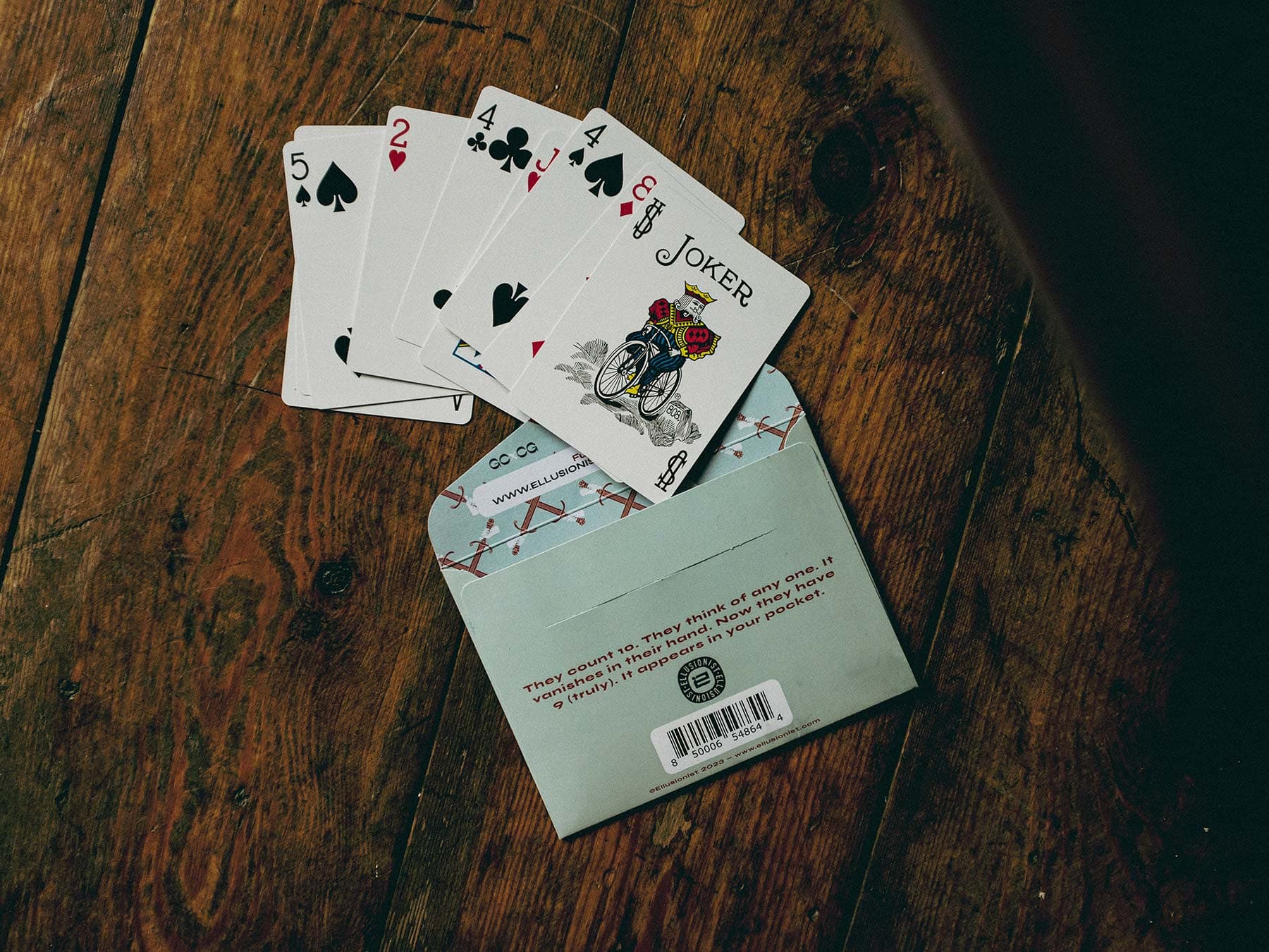 Playing cards and an envelope on a wooden table